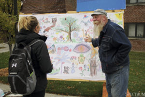 LARISA KHANARINA The Spectrum | Paul Wislotski stood outside the Memorial Union and encouraged students of all drawing capabilities to add to his creative mural